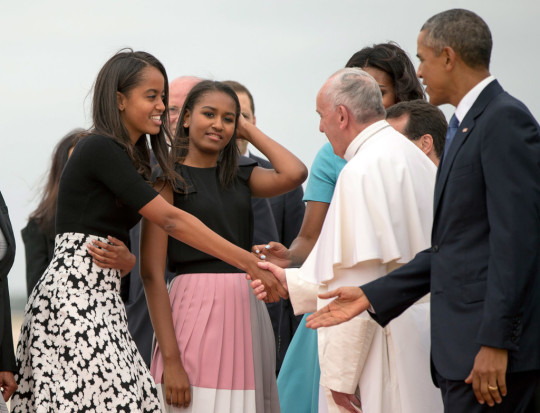President Barack Obama, right, and his daughters Malia Obama, left, and Sasha Obama, second from left, greet Pope Francis upon his arrival at Andrews Air Force Base, Md., Tuesday, Sept. 22, 2015. (AP Photo/Andrew Harnik)