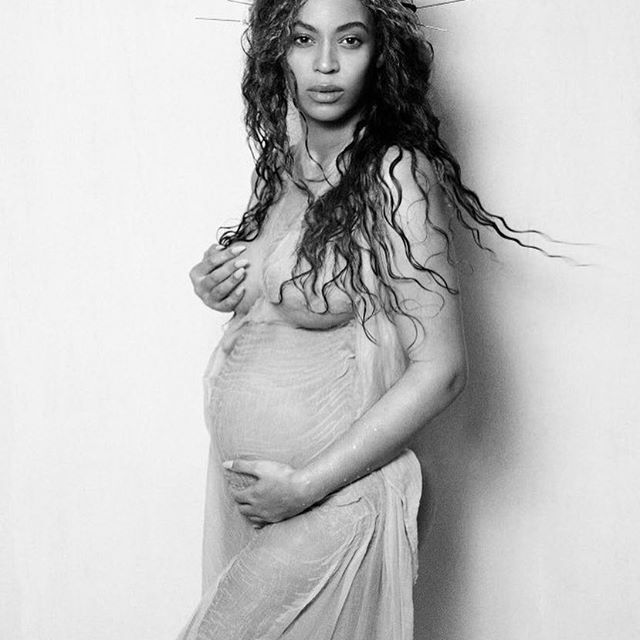 Beyonce Cradles her growing baby bump.