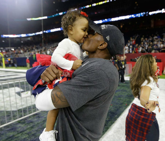 Jonathan Jones celebrates with his daughter Skyler after defeating the Atlanta Falcons in the NFL Super Bowl 51 football game Sunday, Feb. 5, 2017, in Houston. The Patriots defeated the Falcons 34-28