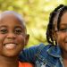 African American kids smiling.