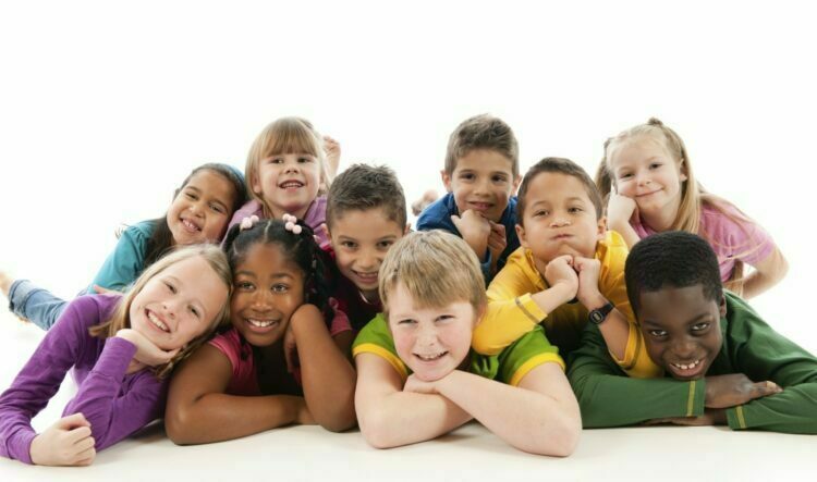 A group of very happy children on a white background.