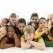 A group of very happy children on a white background.