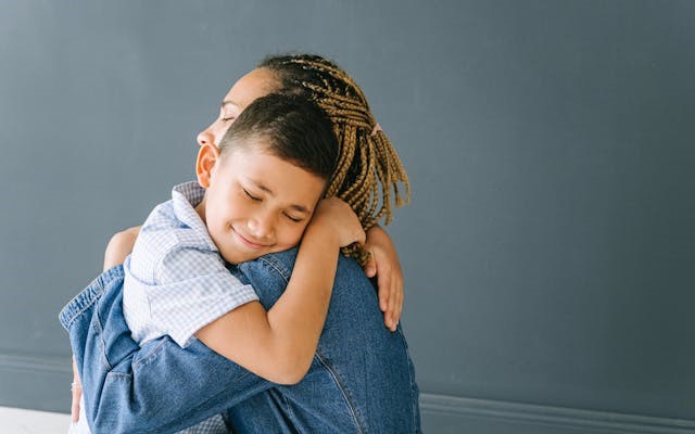 Mother hugging son. PEXELS.COM